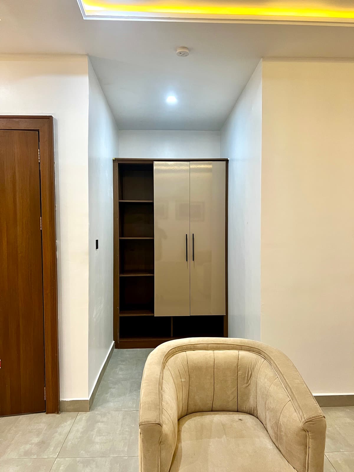 Hallway with a wardrobe and a cream armchair