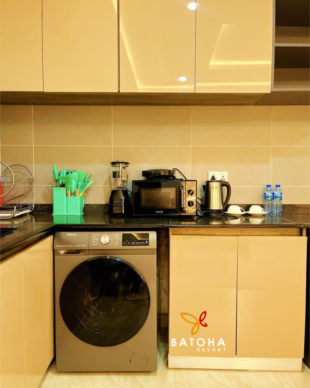 Kitchen with a built-in washing machine and a black countertop