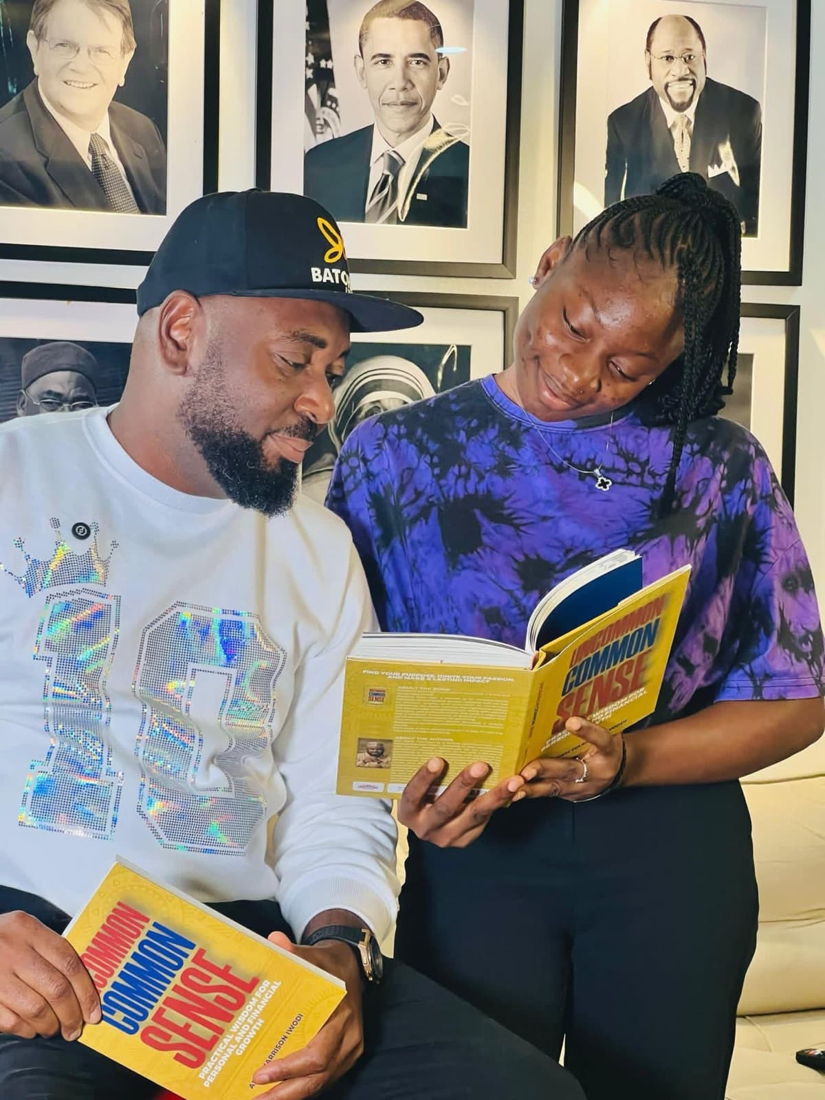 Two people reading a copy of Uncommon Common Sense together