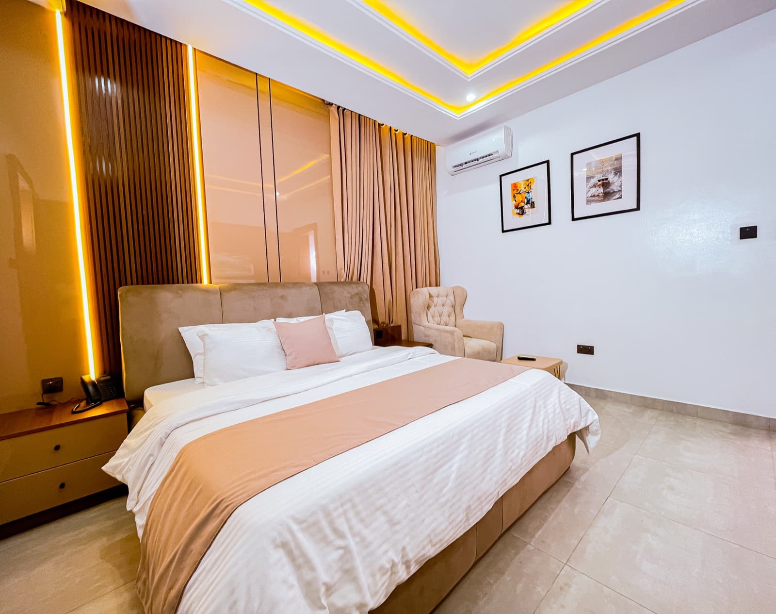 Bedroom with a ribbed wooden headboard wall and gold LED ceiling trim
