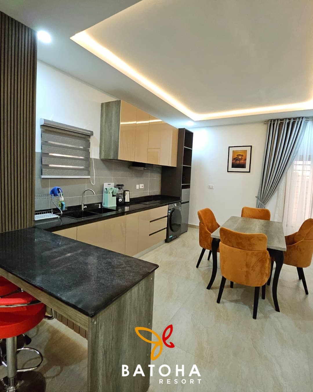 Kitchen and dining area with orange upholstered chairs