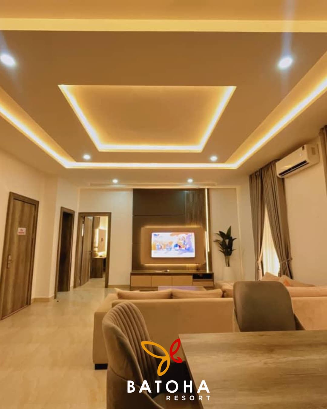 Living room with a lit ceiling recess, TV wall and dining chair