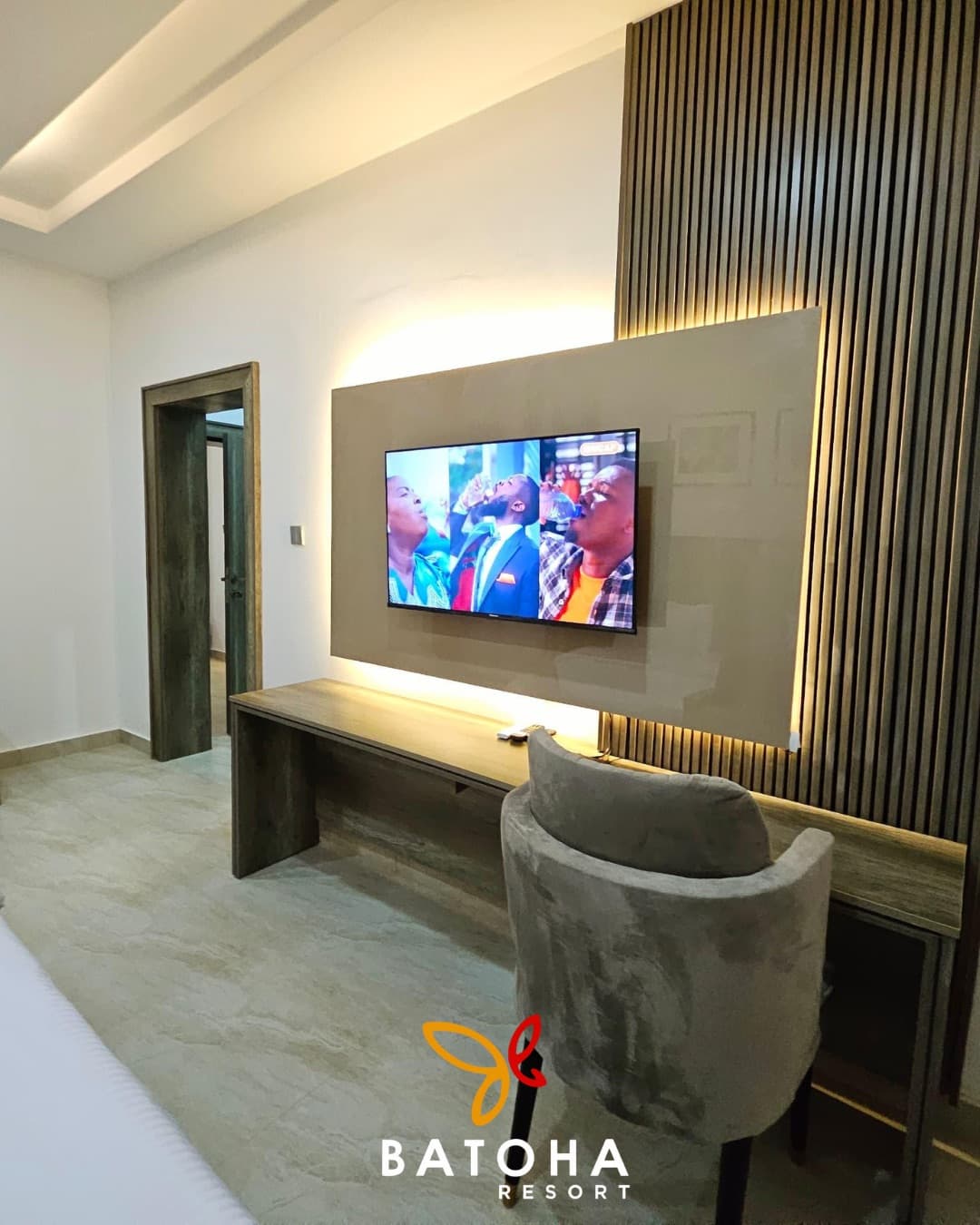 Ribbed wood TV wall with a grey upholstered chair