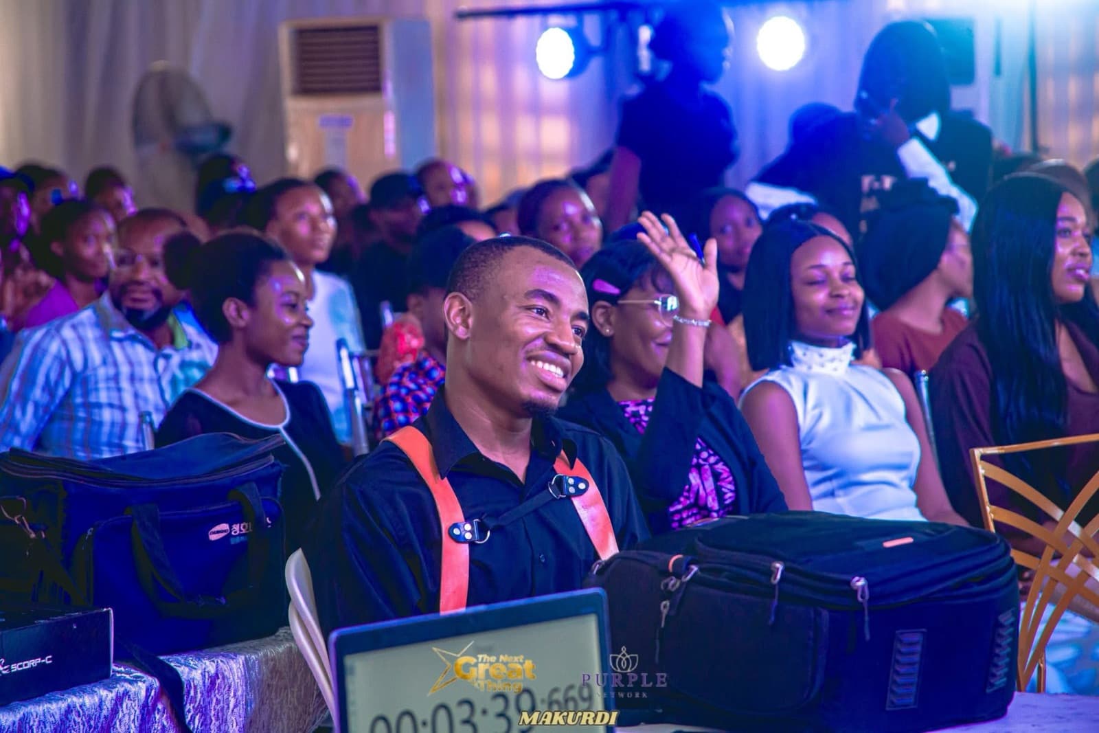 Smiling audience members seated at the summit