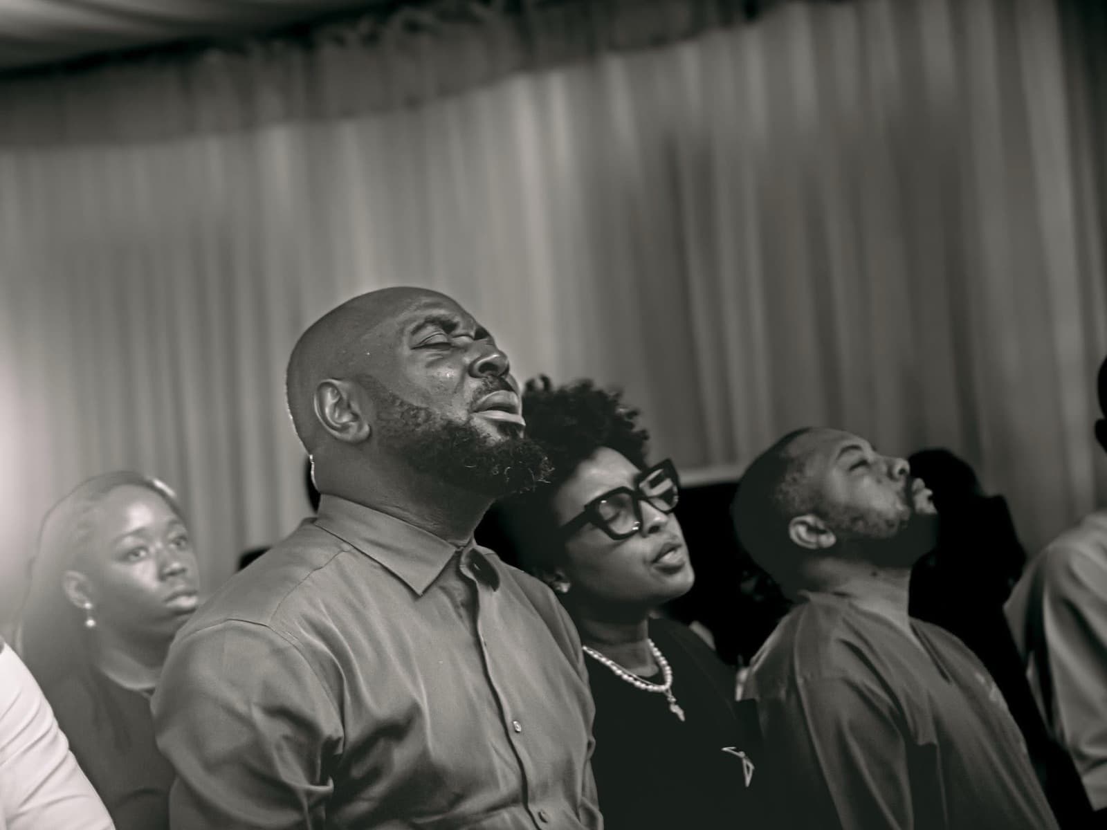 Black-and-white photo of attendees looking upward