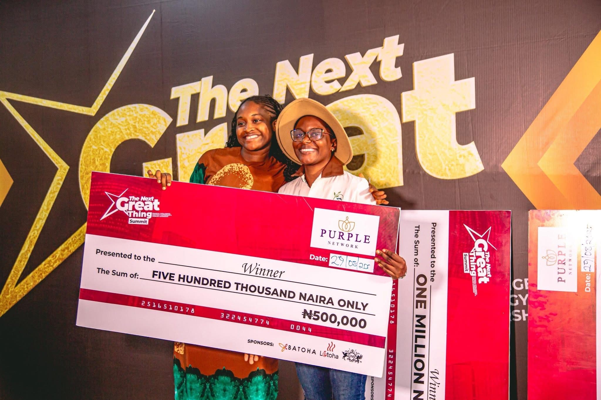 Two winners holding a five hundred thousand naira prize cheque at The Next Great Thing Summit