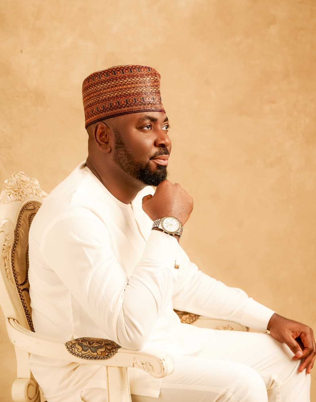 Apeh Harrison Iwodi, seated portrait in white traditional attire